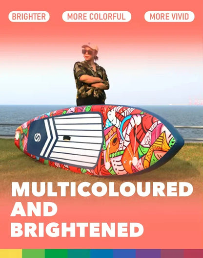 Wearing sunglasses and a cap, a person stands behind the Skatinger Graffiti Paddle Board with vibrant abstract patterns by the water. Text: MULTICOLOURED AND BRIGHTENED. Labels: BRIGHTER, MORE COLORFUL, MORE VIVID.